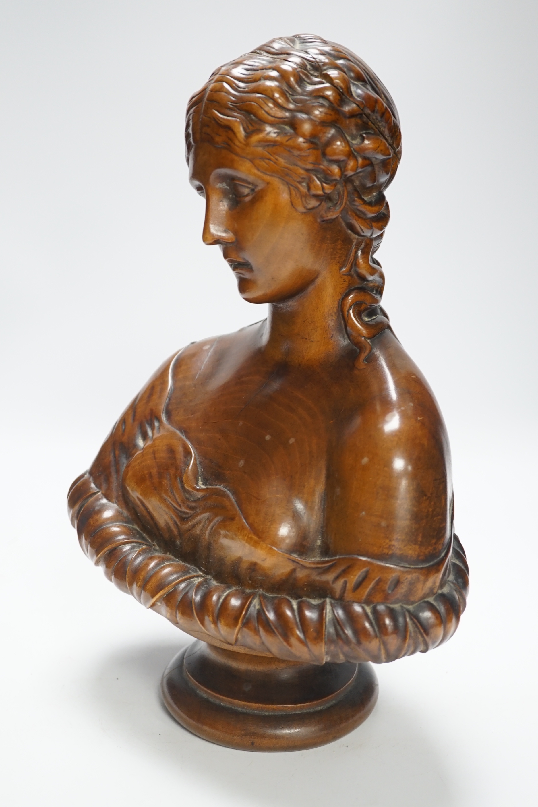 A carved walnut bust of Clytie, possibly Italian, 35cm high